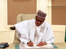 President Muhammadu Buhari of Nigeria signing an offficial document